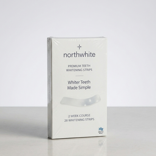 A boxed product labeled northwhite Premium Teeth Whitening Strips stands upright on a light gray surface against a pale gray background. The package is mostly white with black text and a small blue logo near the bottom.
